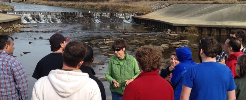 class on a field trip at a dam